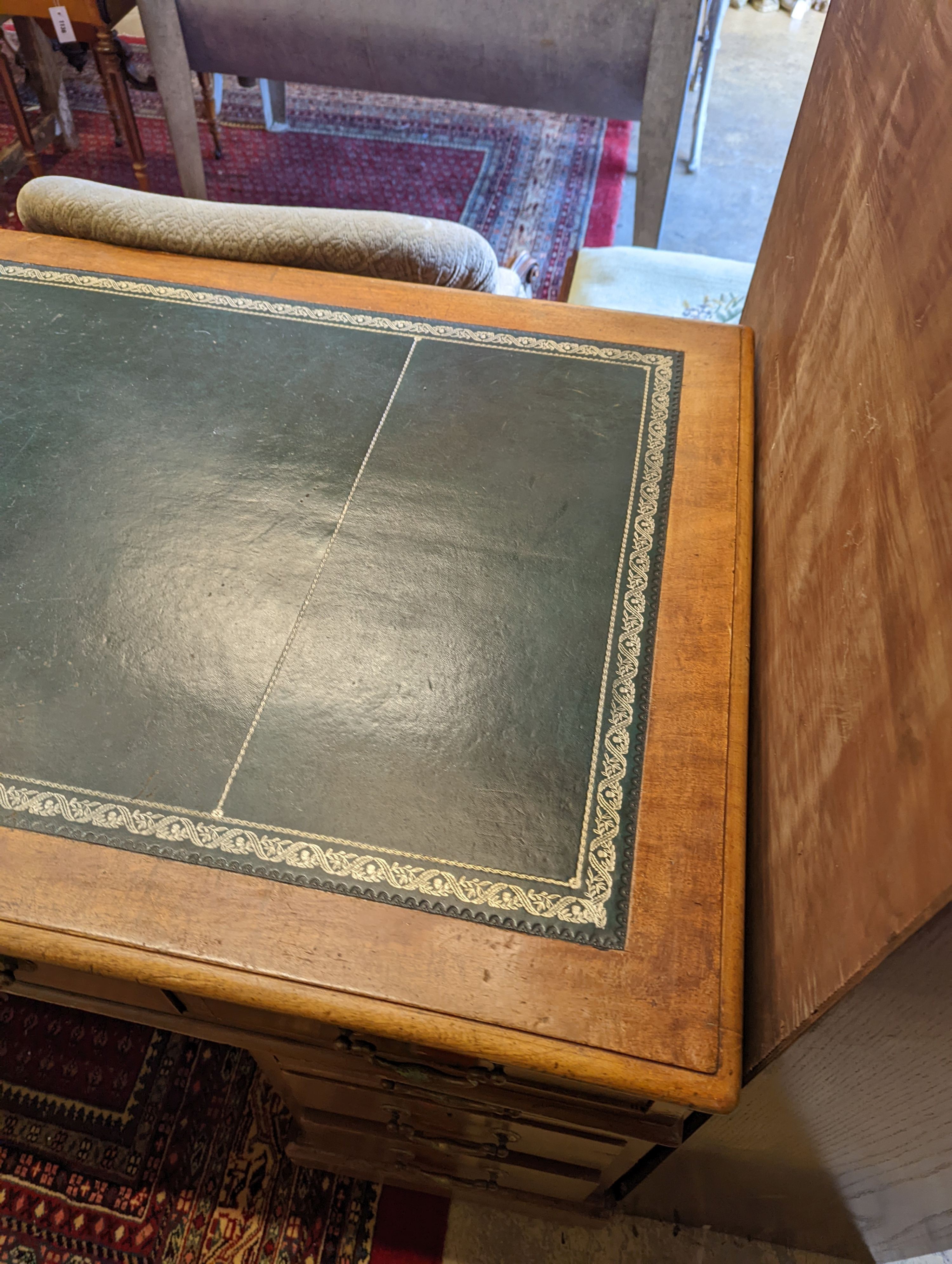 An Edwardian faded mahogany pedestal desk, stamped T. Willson, Great Queen Street, London, length 136cm, depth 76cm, height 76cm